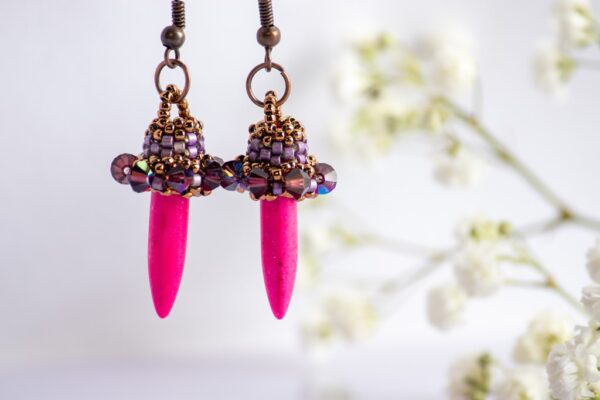 Pink spiked earrings in purple colors
