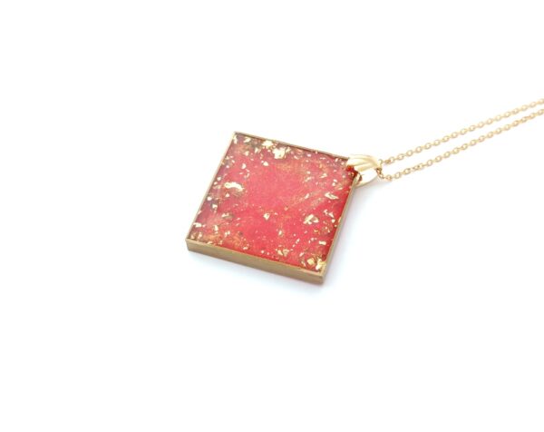 Large cube resin pendant is red and gold colors
