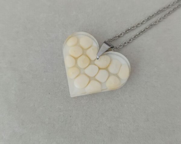 Floating stones in light yellow color, resin heart pendant
