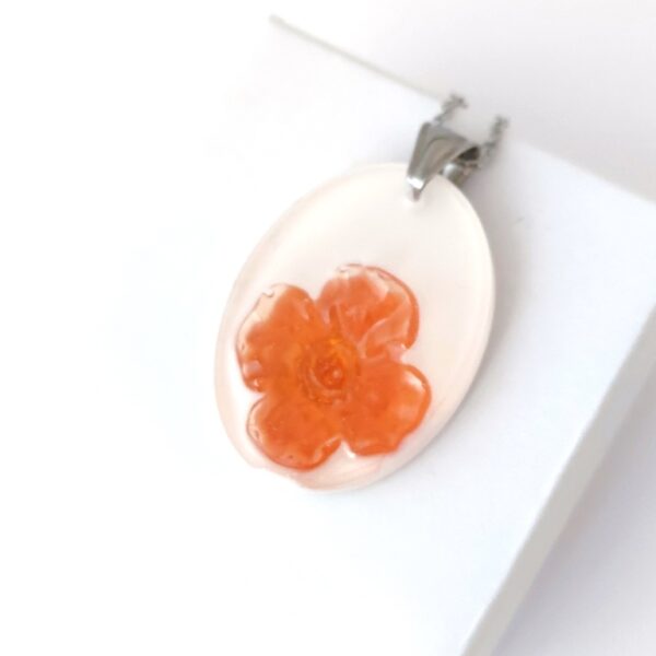Peach blossoms in white oval resin pendant