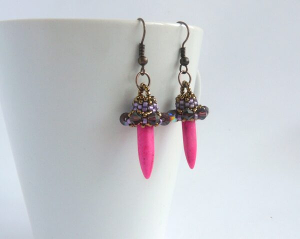 Pink spiked earrings in purple colors