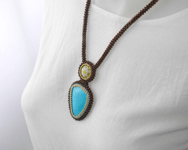 Turquoise and ceramic pendants, in a bronze frame