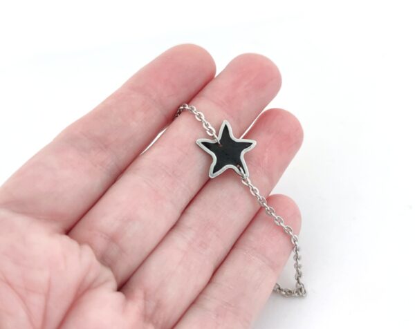 Black resin star on stainless steel chain bracelet