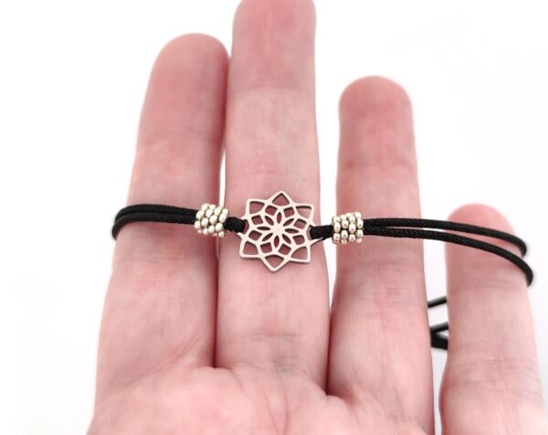 Cord bracelet with a silver color mandala pendant
