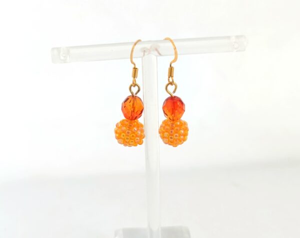 Long earrings with beaded beads in orange color