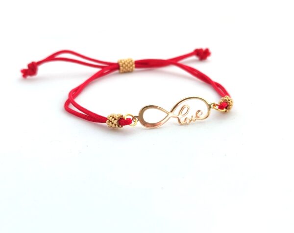 Cord bracelet with a gold love sign pendant