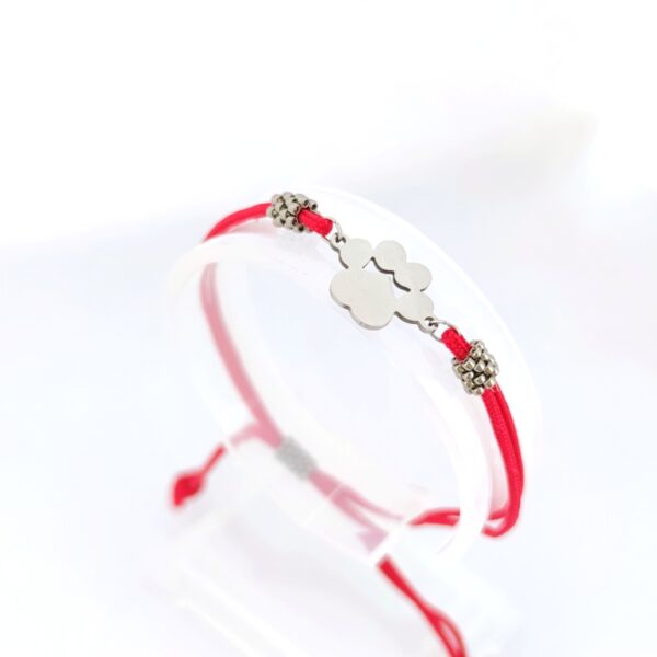 Cord bracelet with a silver color paw pendant in red