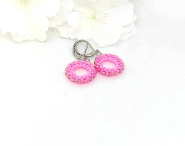 Small hoop earrings in pink and purple colors