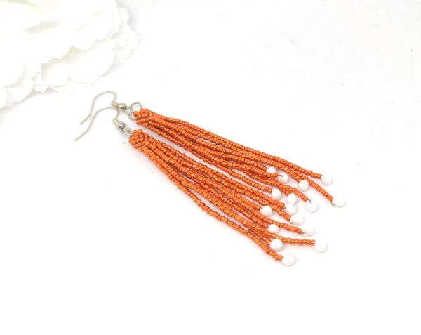 Fringe earrings in metallic orange color