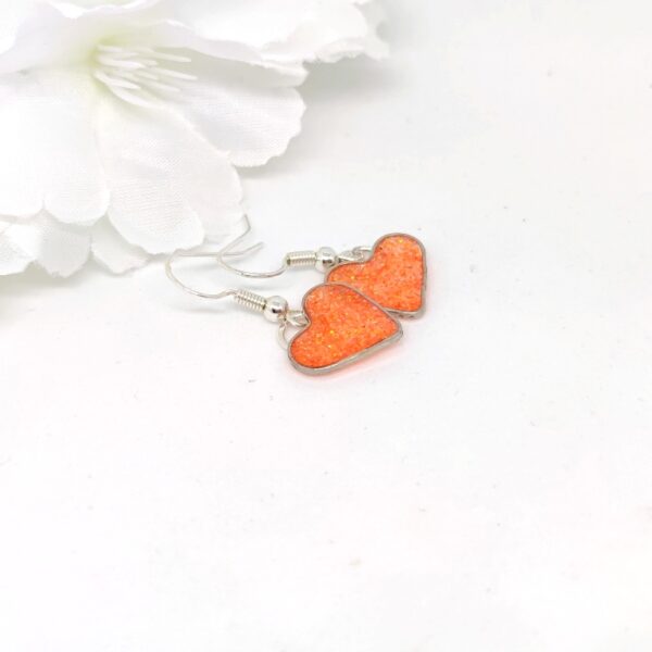Heart earrings with orange glitter