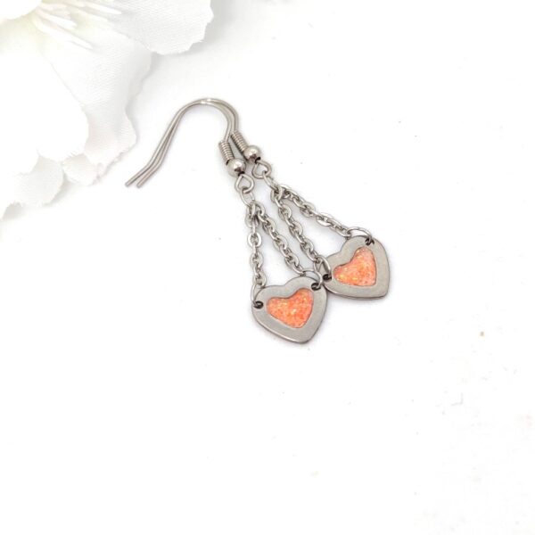 Heart earrings with chain, orange glitter