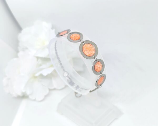 Bubbles with resin in glittery orange color, stainless steel bracelet