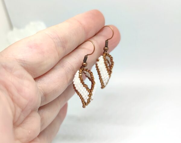 Twisted, beaded earrings in bronze and white colors