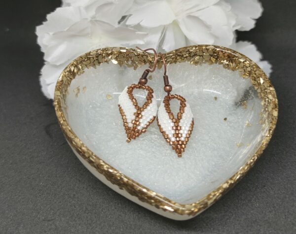 Twisted, beaded earrings in bronze and white colors