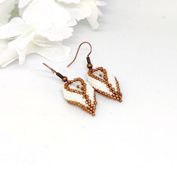 Twisted, beaded earrings in bronze and white colors