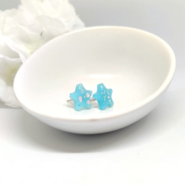 Star shaped, resin stud earrings in aqua blue color